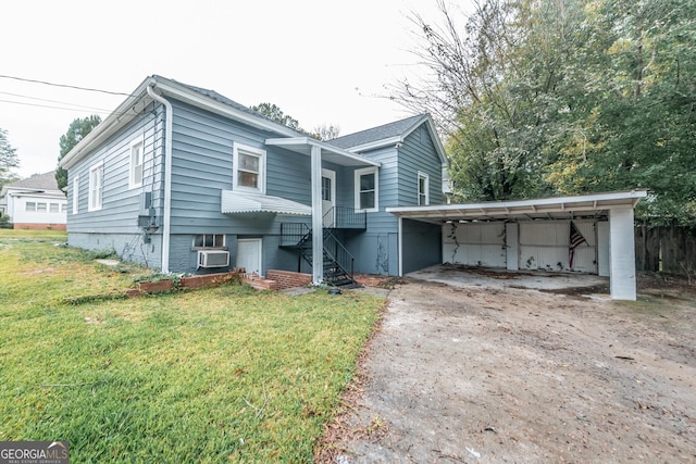 view of front of house with a front yard and a carport