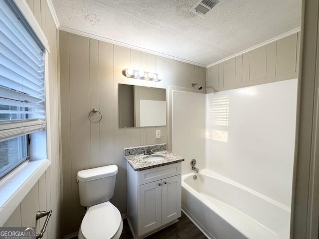 full bathroom featuring wood walls, toilet, a wealth of natural light, and bathtub / shower combination