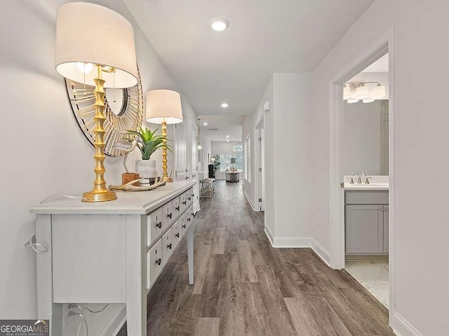 hall with dark hardwood / wood-style flooring and sink