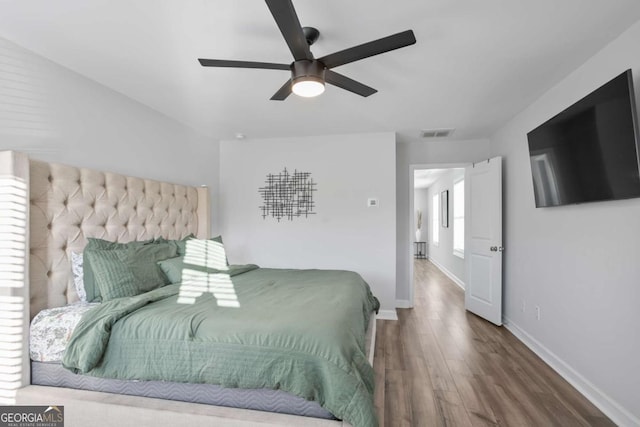 bedroom with ceiling fan and hardwood / wood-style floors