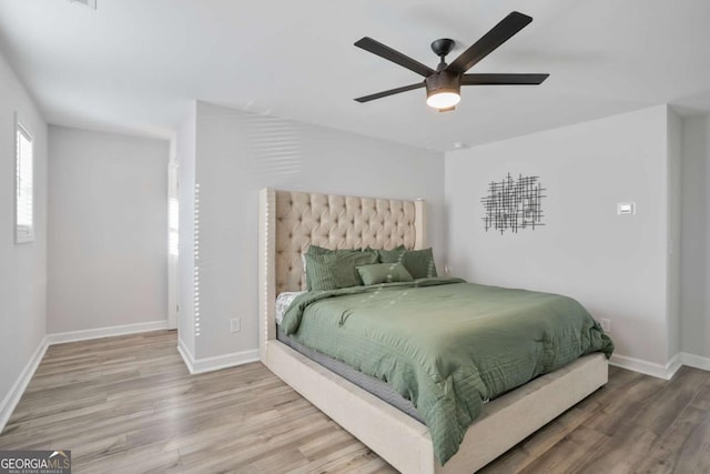 bedroom featuring hardwood / wood-style flooring and ceiling fan