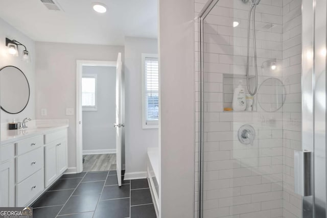 bathroom featuring tile patterned floors, vanity, and shower with separate bathtub