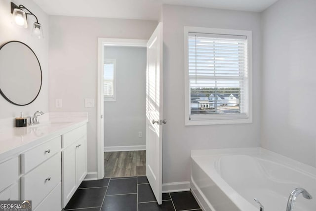 bathroom with tile patterned floors, vanity, and a bath