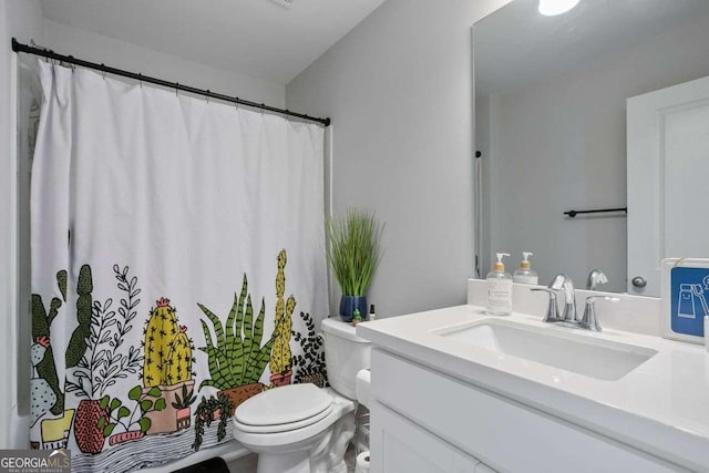 bathroom featuring vanity and toilet