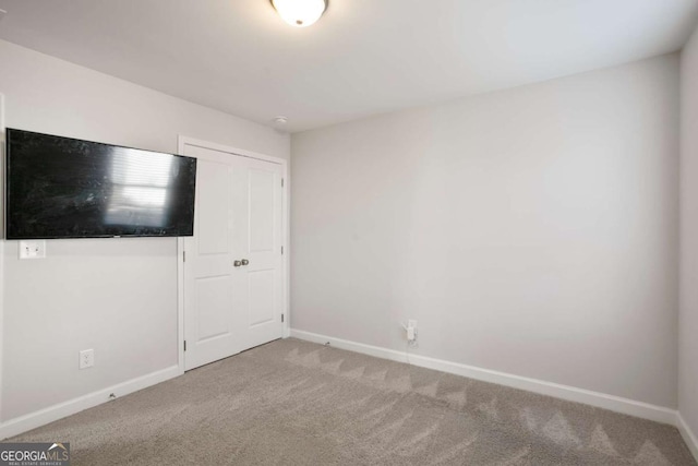 unfurnished bedroom with carpet and a closet