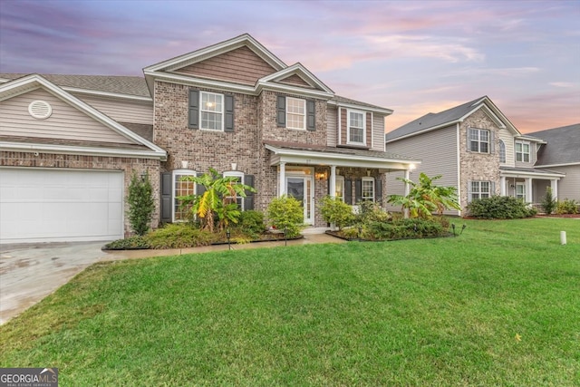 view of front of property featuring a garage and a yard