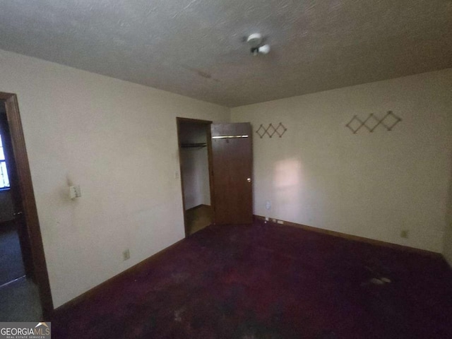 unfurnished bedroom featuring dark carpet