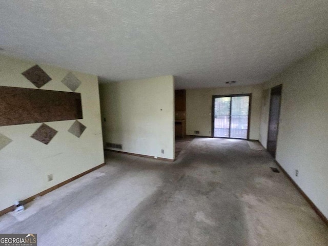 spare room with carpet floors and a textured ceiling