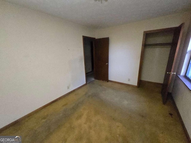 unfurnished bedroom with carpet floors and a closet