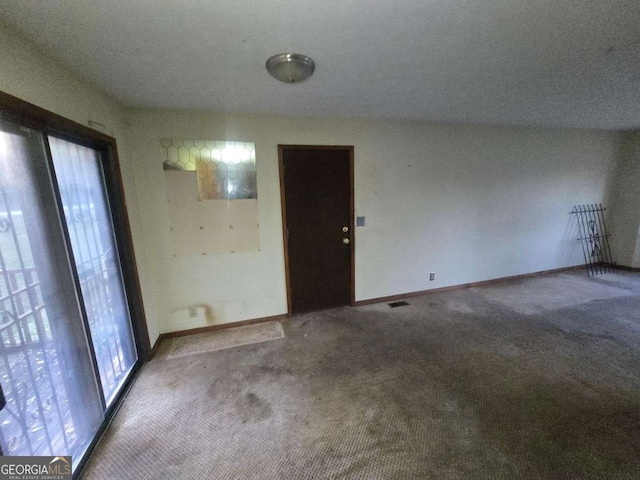 interior space featuring carpet and a textured ceiling