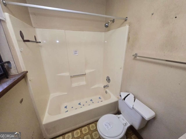 bathroom with shower / bathtub combination and toilet