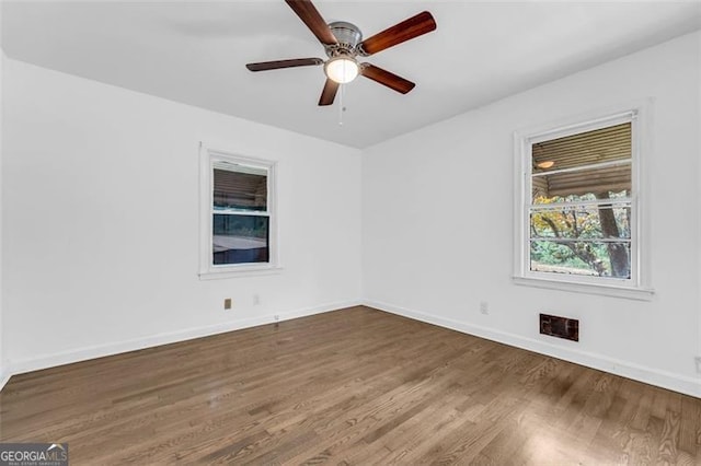 empty room featuring hardwood / wood-style floors and ceiling fan