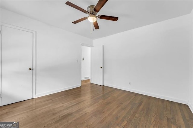 unfurnished room featuring ceiling fan and dark hardwood / wood-style flooring