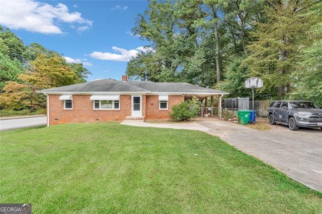 view of front of property with a carport and a front lawn