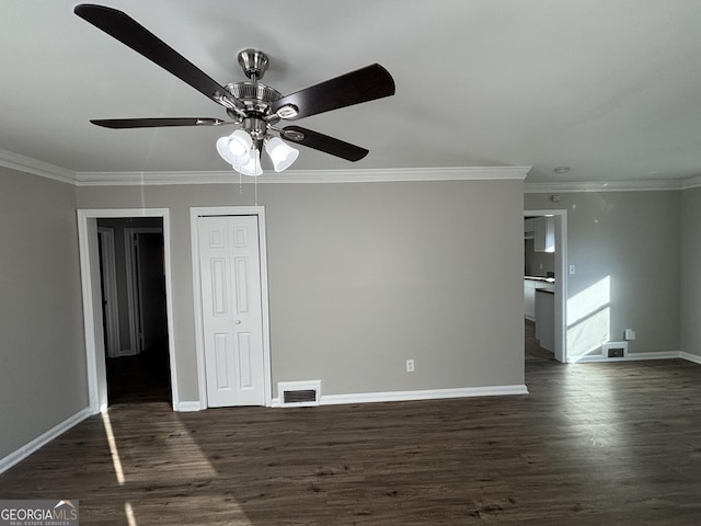 spare room featuring ceiling fan, crown molding, and dark hardwood / wood-style floors