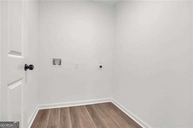 clothes washing area featuring electric dryer hookup, wood-type flooring, and hookup for a washing machine