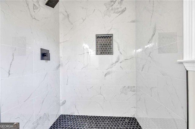 bathroom with a tile shower