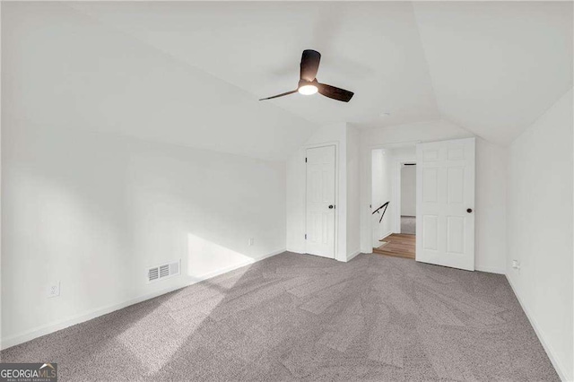 bonus room featuring ceiling fan, carpet, and lofted ceiling