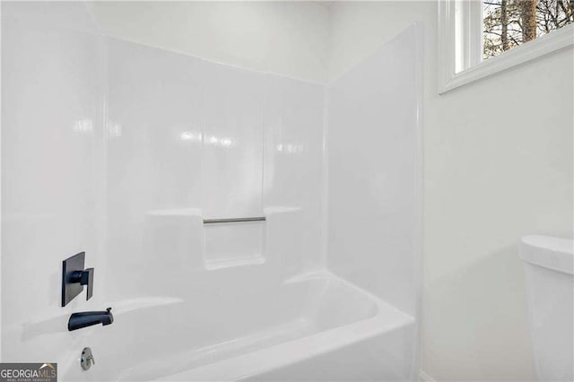 bathroom with shower / bathtub combination and toilet