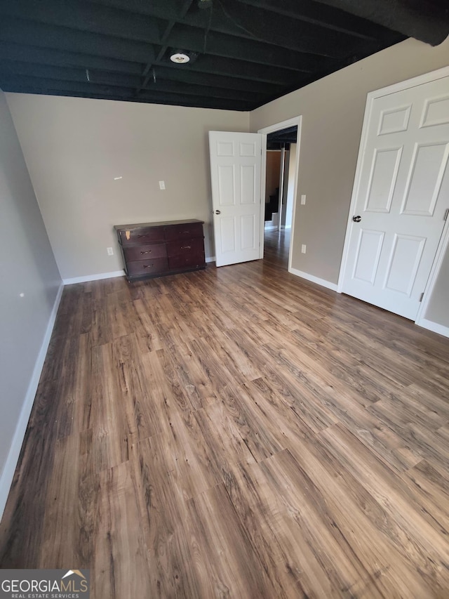 interior space featuring hardwood / wood-style flooring and beamed ceiling