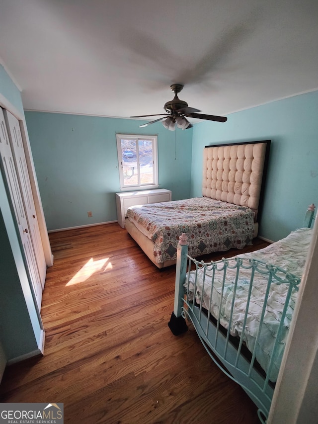 bedroom featuring hardwood / wood-style floors and ceiling fan