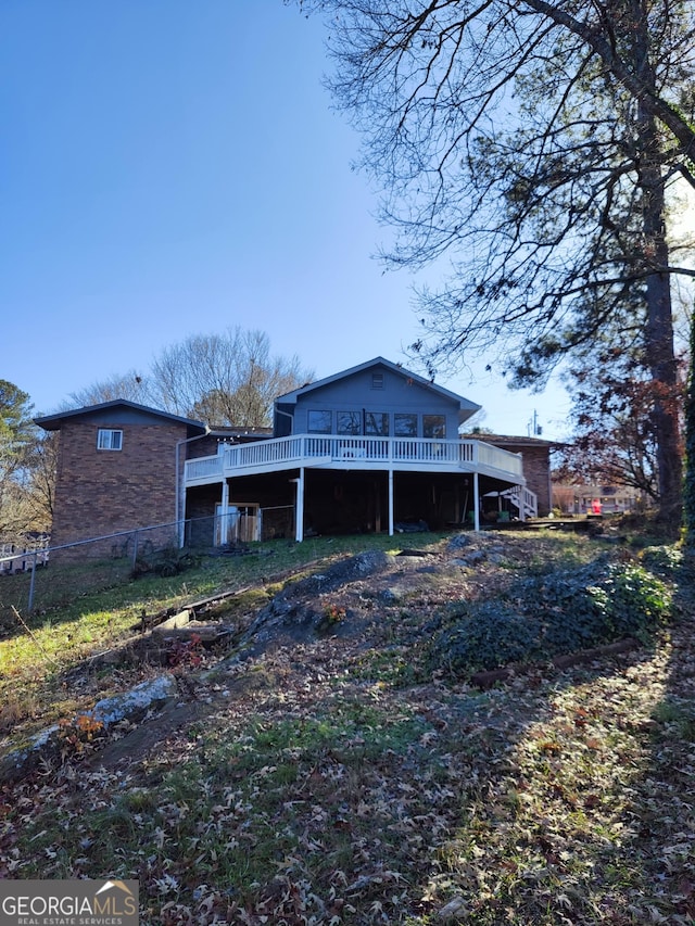 back of house featuring a deck