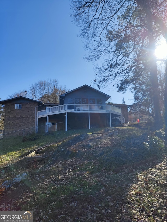 view of property exterior with a deck