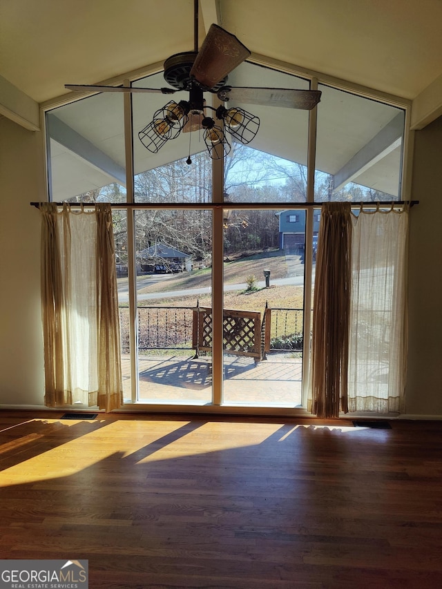 doorway featuring ceiling fan, plenty of natural light, hardwood / wood-style floors, and vaulted ceiling