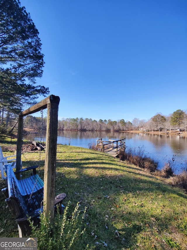 dock area featuring a water view and a yard