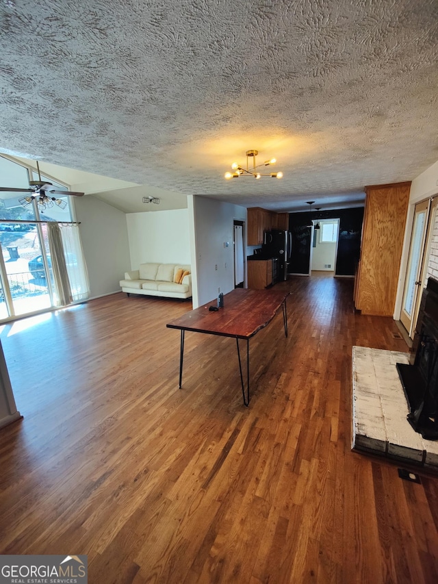 unfurnished living room with hardwood / wood-style flooring, ceiling fan, and a textured ceiling