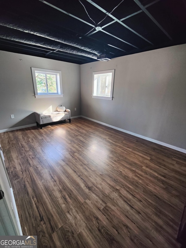 spare room featuring dark wood-type flooring