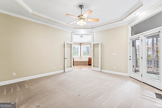 spare room featuring french doors, a wealth of natural light, and ornamental molding