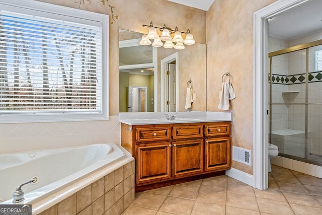 full bathroom with tile patterned flooring, shower with separate bathtub, and toilet