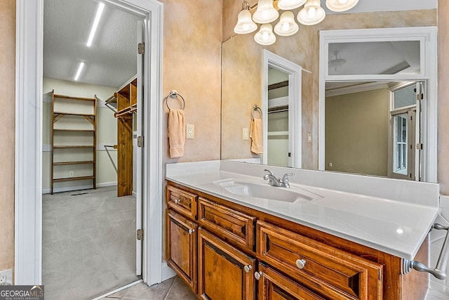 bathroom with vanity, a textured ceiling, and tile patterned flooring