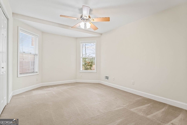 unfurnished room featuring ceiling fan and light colored carpet