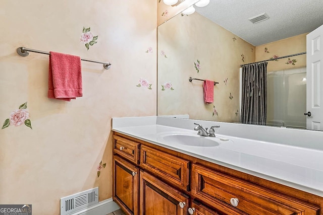 bathroom with vanity, a shower with curtain, and a textured ceiling