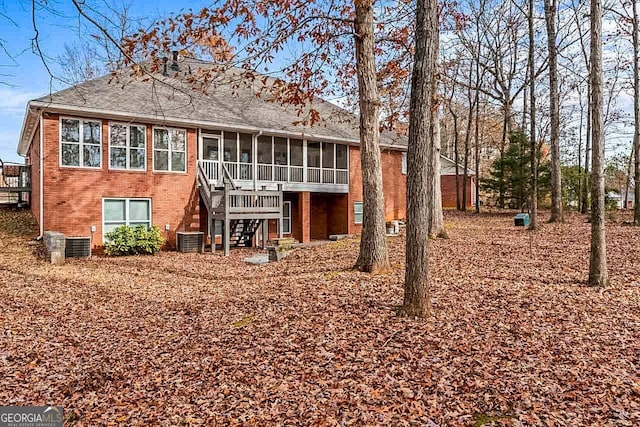 back of house featuring a sunroom and cooling unit