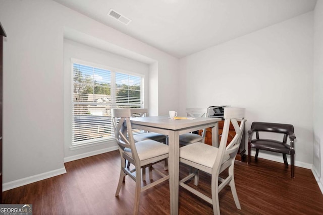 dining space featuring dark hardwood / wood-style floors