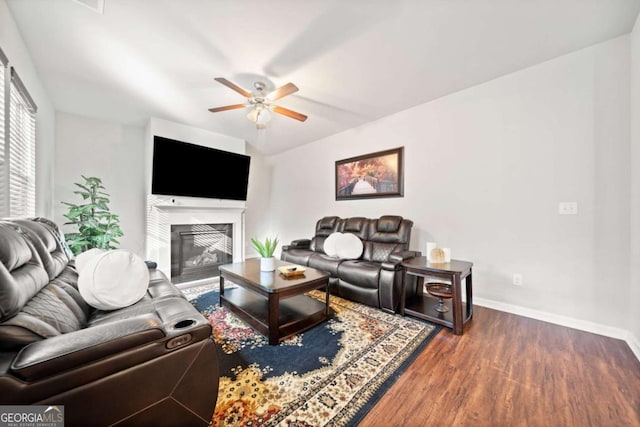 living room with ceiling fan and dark hardwood / wood-style flooring