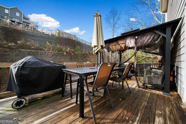 wooden deck featuring a grill