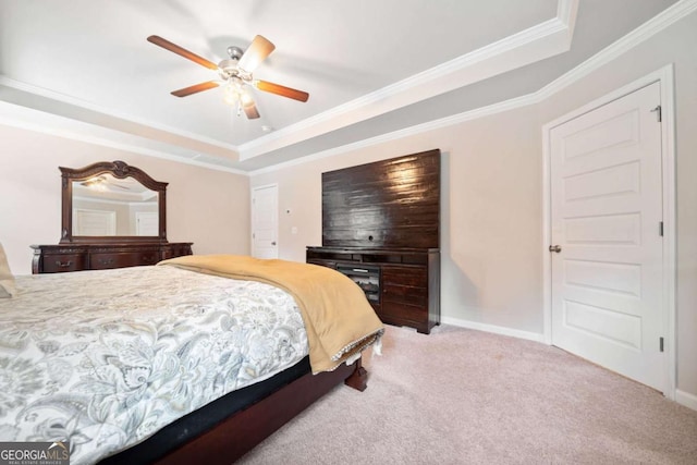 carpeted bedroom featuring a raised ceiling, ceiling fan, and crown molding