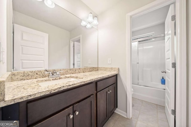 full bathroom with toilet, vanity, tile patterned floors, and bath / shower combo with glass door