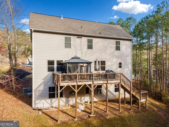 back of property with a gazebo and a wooden deck