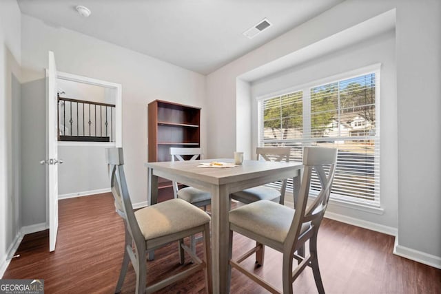 dining space with dark hardwood / wood-style floors