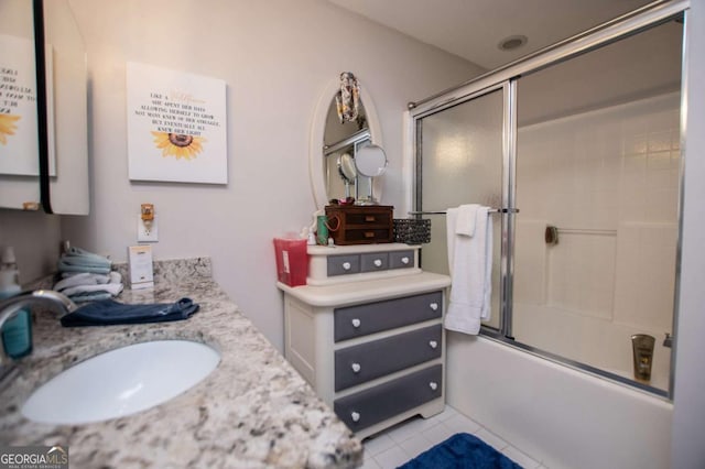 bathroom with tile patterned floors, vanity, and combined bath / shower with glass door