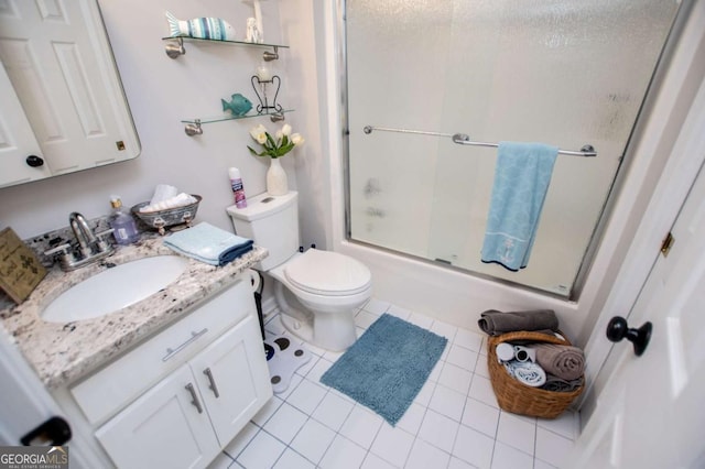 full bathroom with shower / bath combination with glass door, vanity, tile patterned floors, and toilet