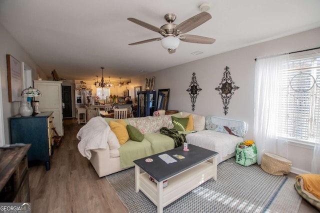 living room featuring hardwood / wood-style floors and ceiling fan