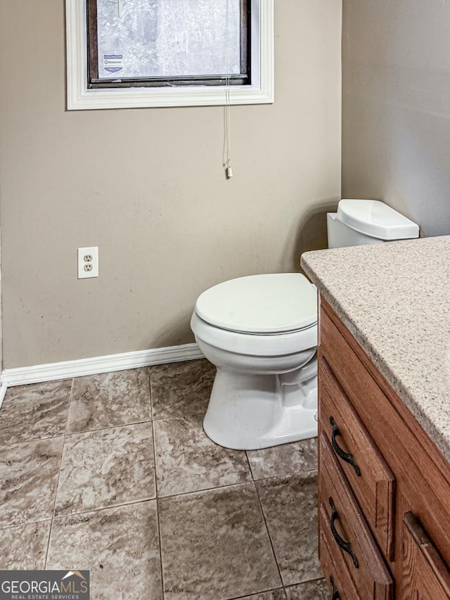 bathroom featuring toilet and vanity