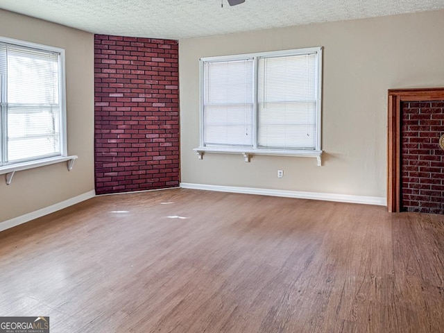 interior space featuring wood-type flooring, a textured ceiling, and ceiling fan