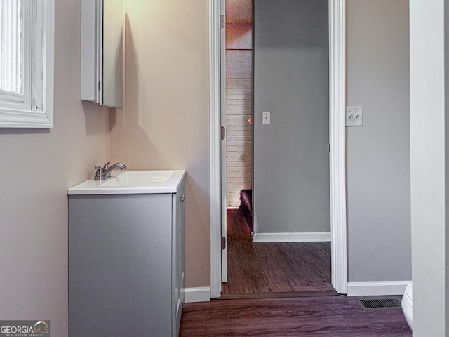 bathroom with hardwood / wood-style floors, toilet, and vanity